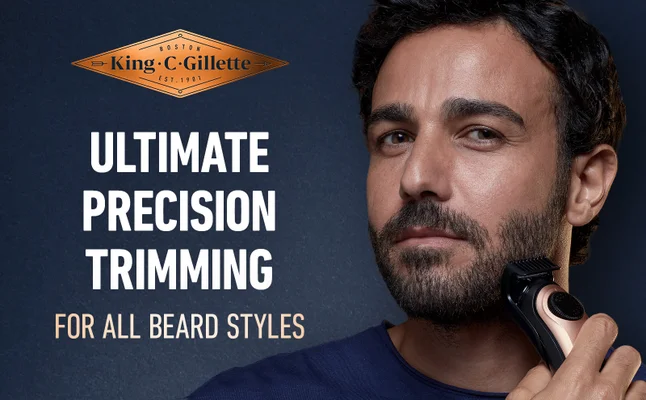 A man is trimming his beard with King C. Gillette Trimmer Pro for all beard types.