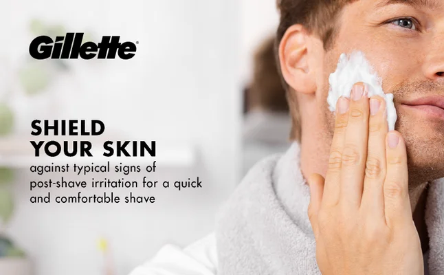 A man is applying Gillette Classic Foam to his cheek for a comfortable shave.