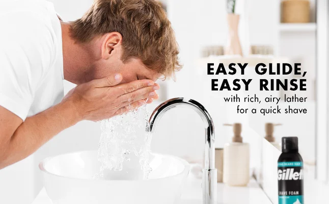 A man is washing his face after using Gillette Classic Foam for a quick shave.