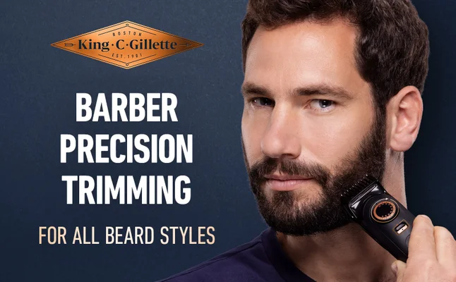 A man is trimming his beard with King C. Gillette Trimmer Pro Max for all beard types.