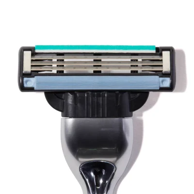 Gillette razor head featuring five blades, a lubrication strip, and a skin guard for a smooth shave.