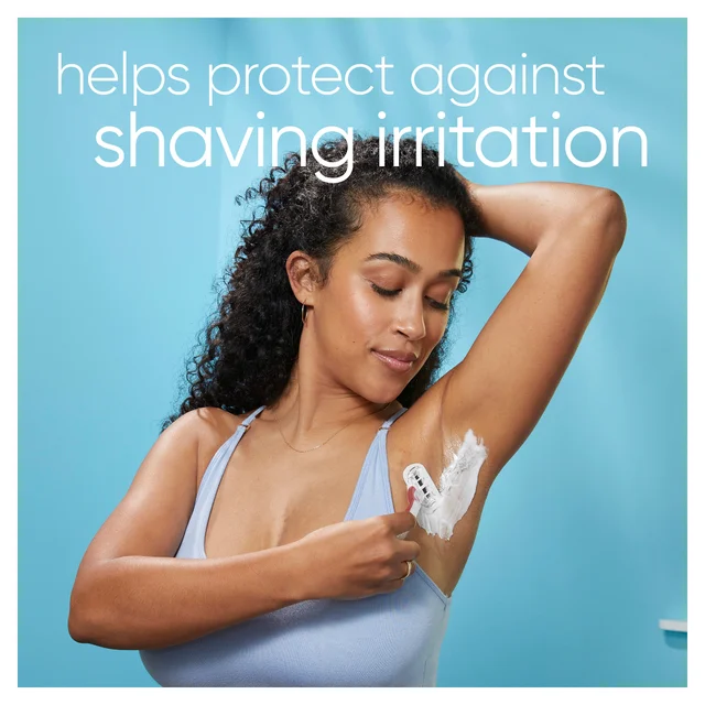 Woman shaving underarm, highlighting protection against shaving irritation.