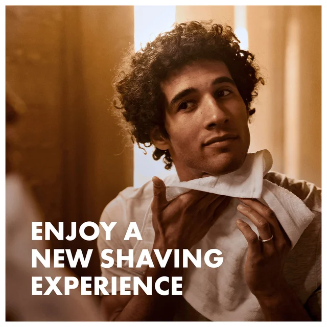 Man drying his face, promoting a new shaving experience.
