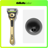 GilletteLabs gold-handled razor and its black charging dock.