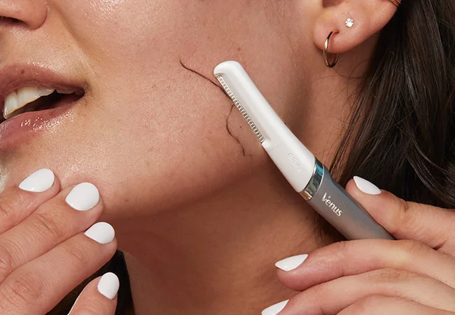 Shaving face with Gillette Venus dermaplaning razor