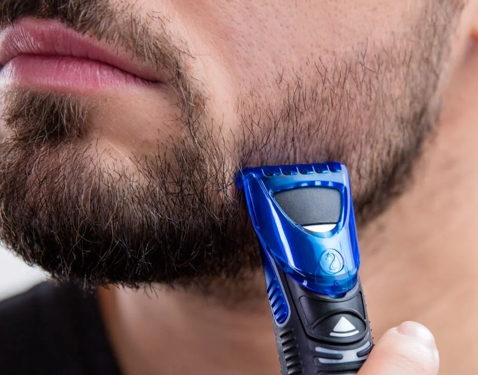 Man trimming beard with Gillette Styler.